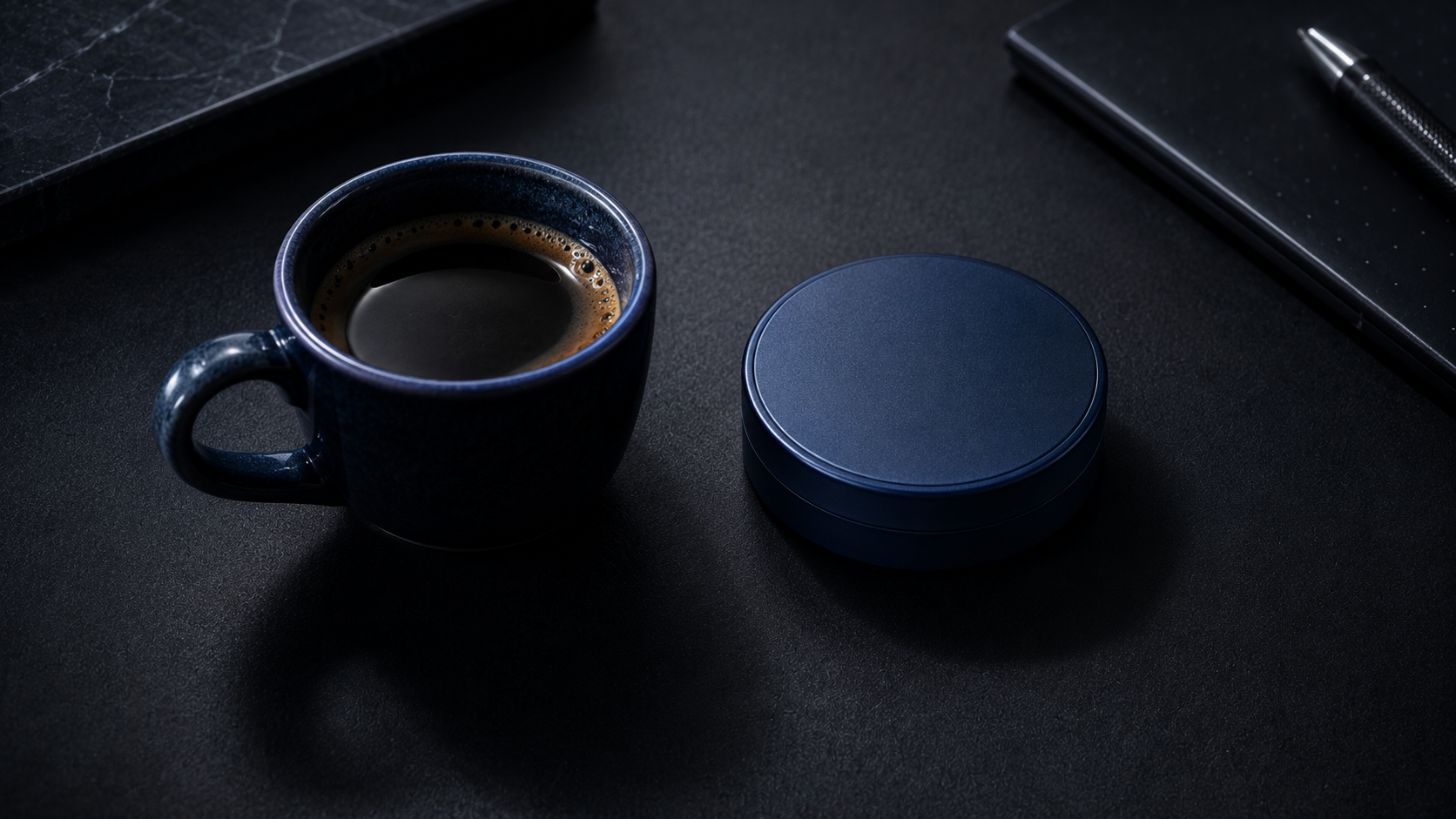 Espresso cup and nicotine pouch on dark desk — caffeine nicotine stack research